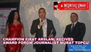 CHAMPION FIRAT ARSLAN RECEIVES HIS AWARD FROM JOURNALIST MURAT TOPCU.
